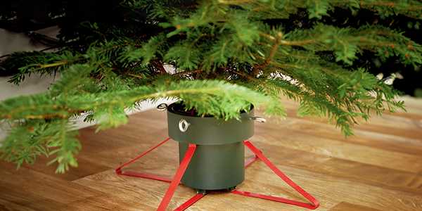 A red coloured Christmas tree stand. 